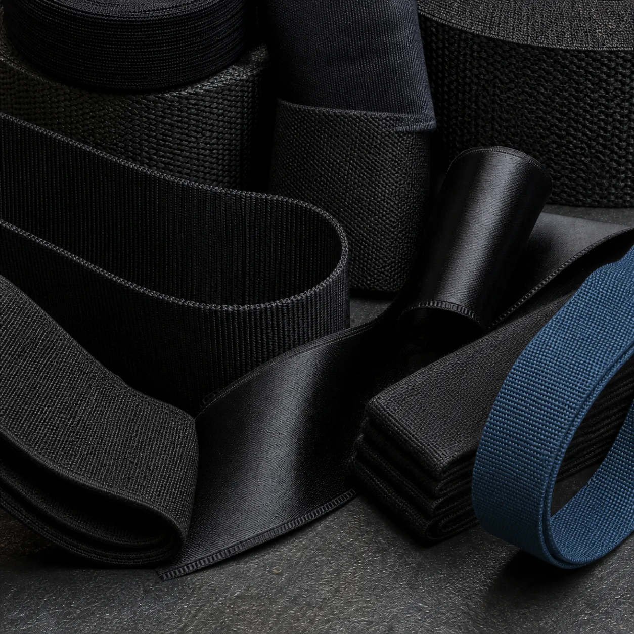 Steel-blue and black woven tapes arranged for material review